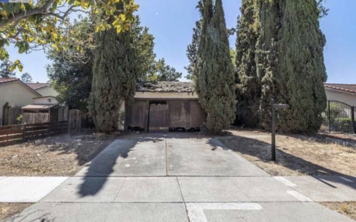 Original house destroyed by fire, roof collapsed and openings boarded