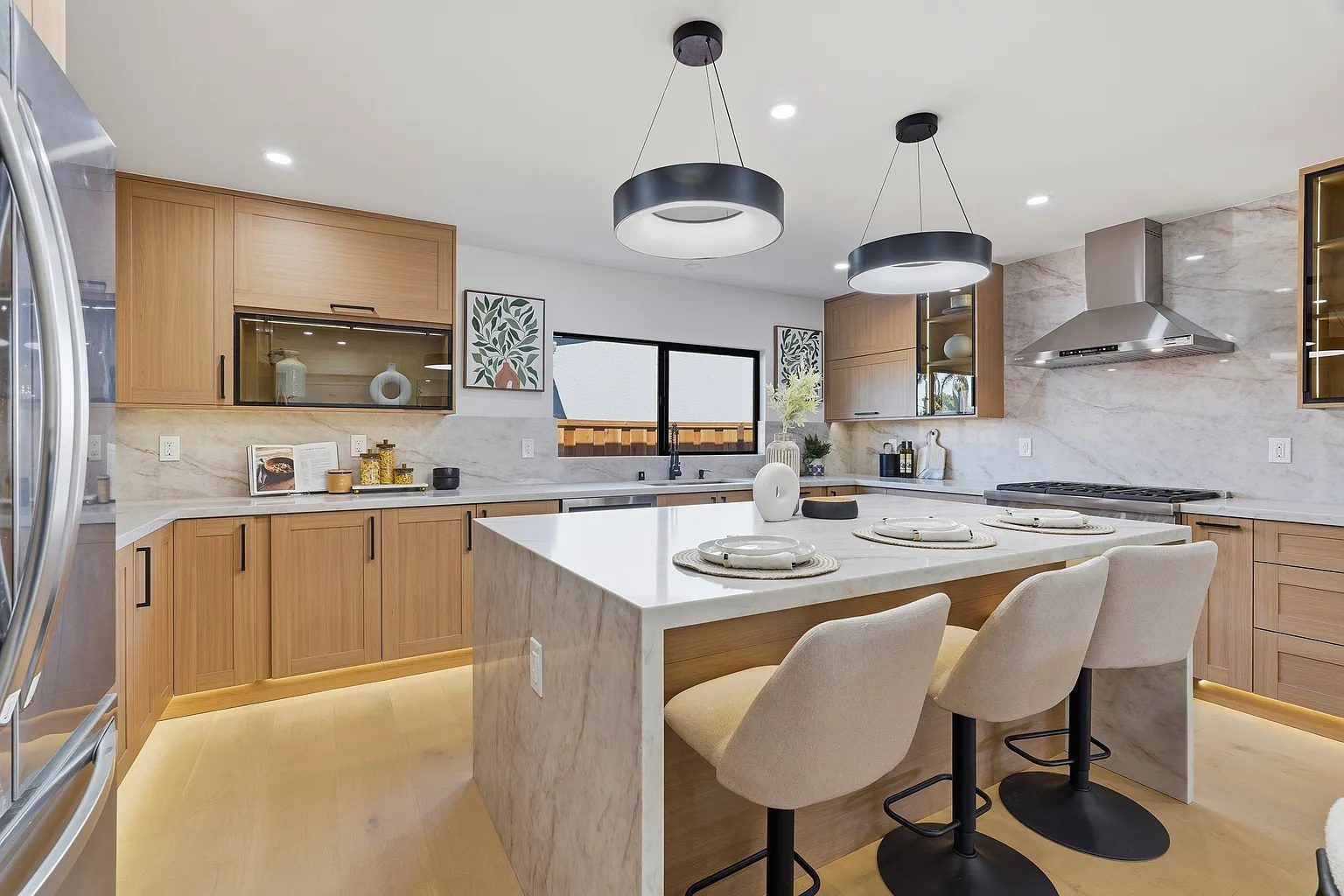Kitchen with white oak cabinetry and marble waterfall island
