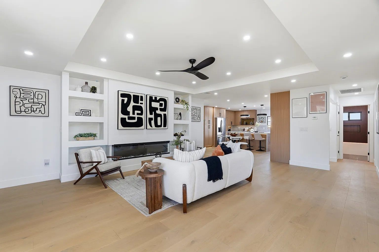 Open great room with built-in shelving and linear fireplace