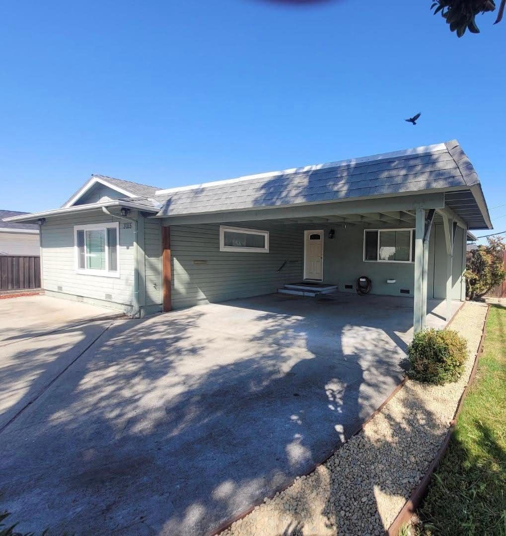 Original green ranch home with open carport