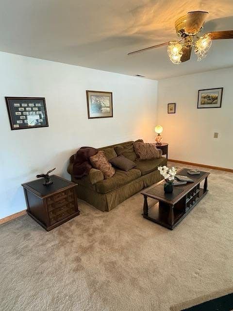Original carpeted living room with dated furnishings